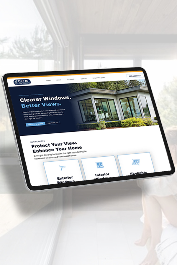 Tablet showing a window cleaning service website with the slogan 'Clearer Windows. Better Views.' and service cards for Exterior, Interior, and Skylights against a houses image on the hero.